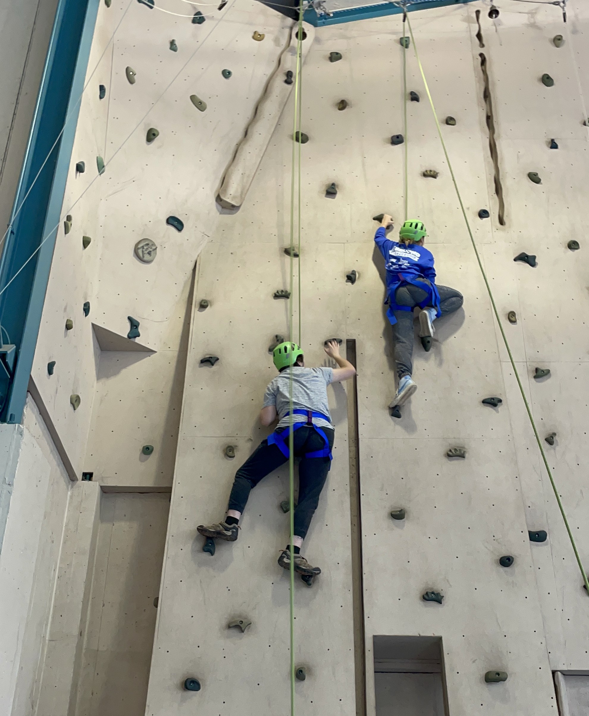 People climbing rock wall 