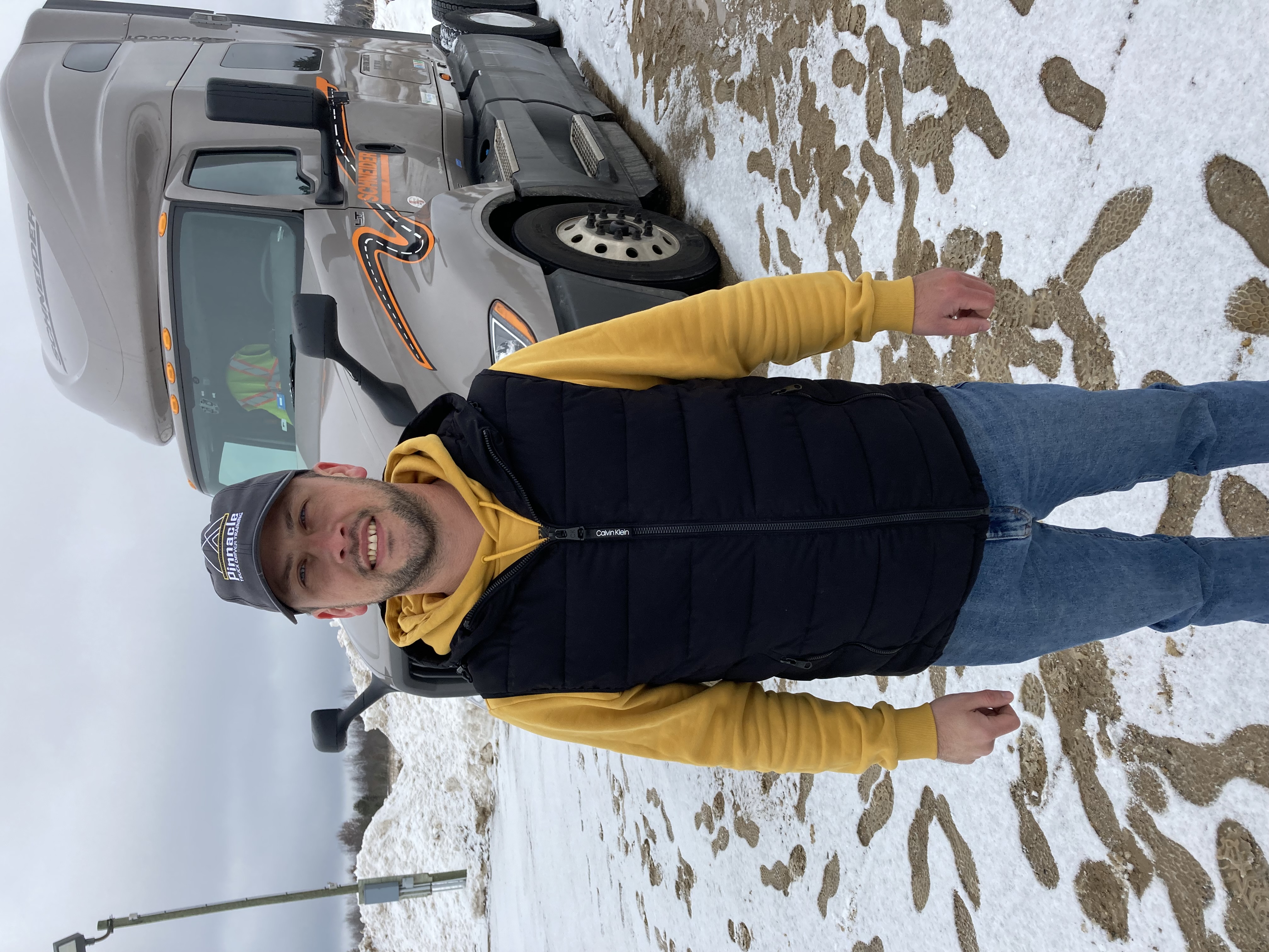 Serhii Korotchenko standing in front transfer truck